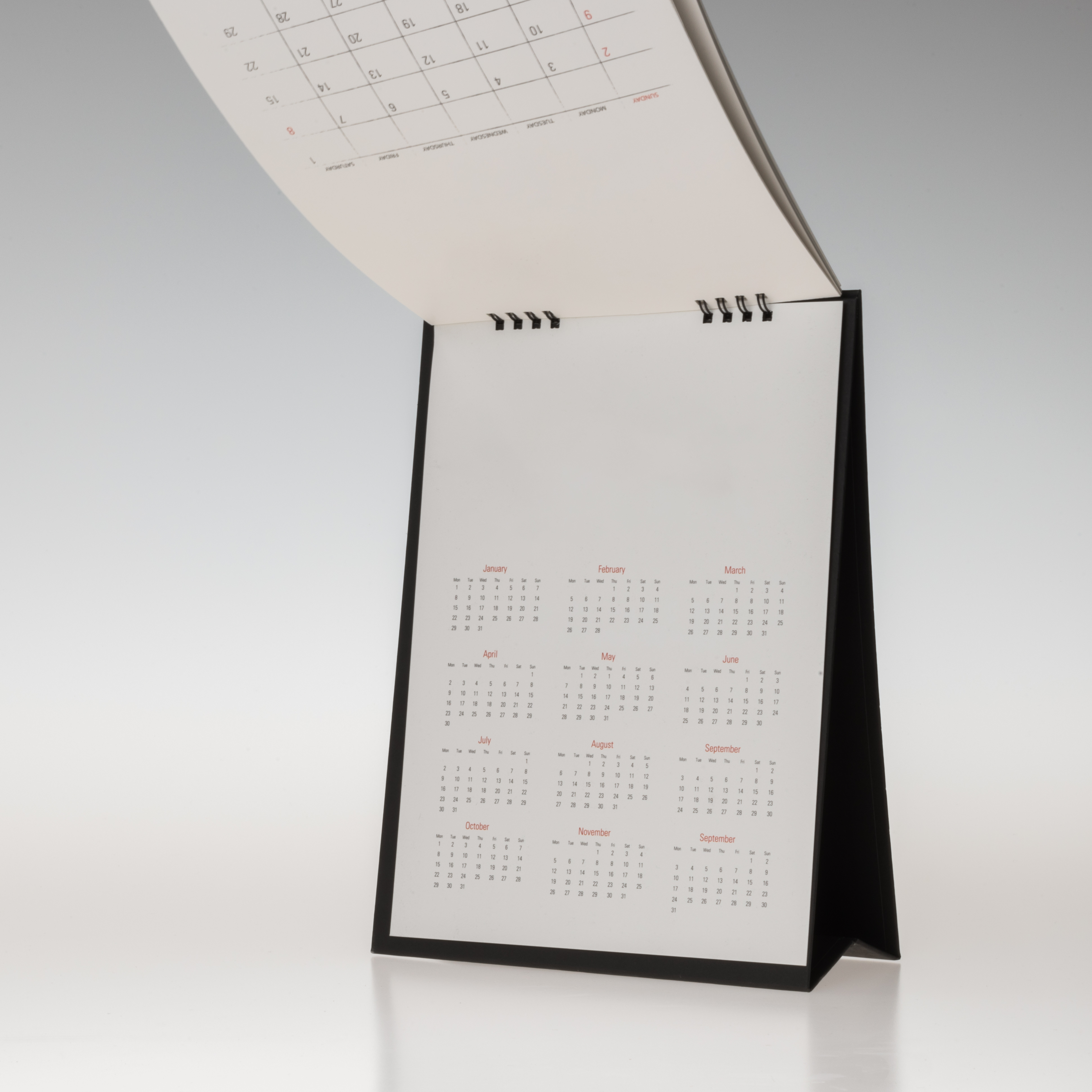 blank-mockup-design-black-cover-paper-spiral-table-calendar-isolated-white-background.jpg