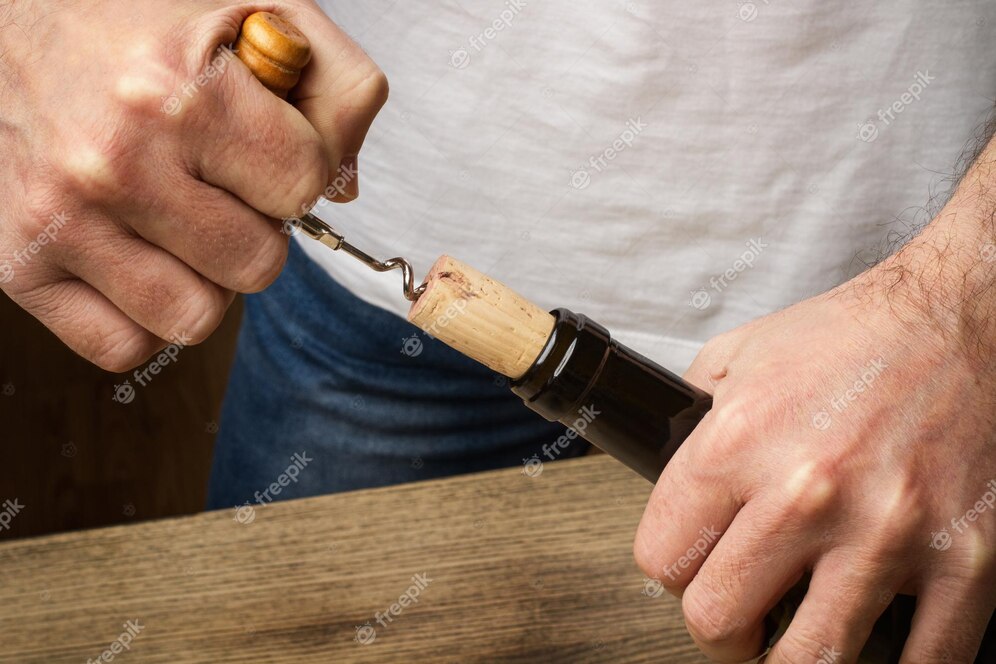 man-opening-bottle-wine-with-handle-corksrew_319172-2717.jpg