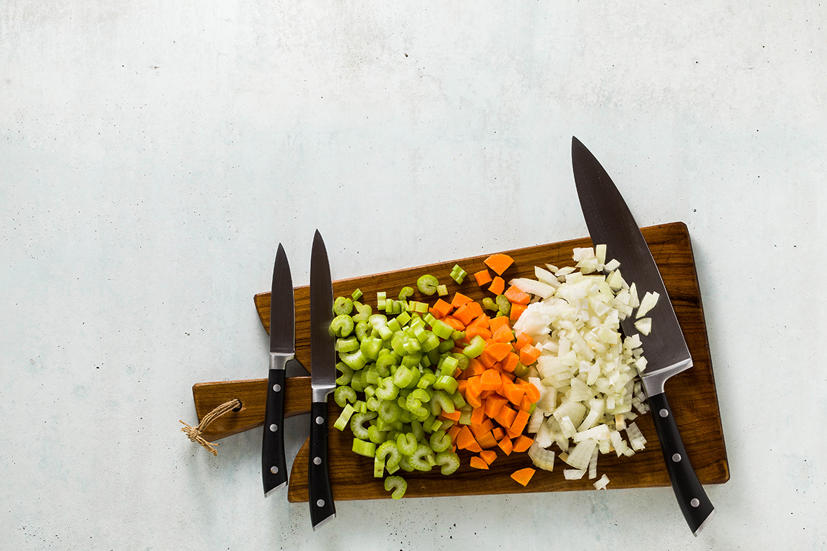 set-knives-wooden-cutting-board-chopped-vegetables.jpg