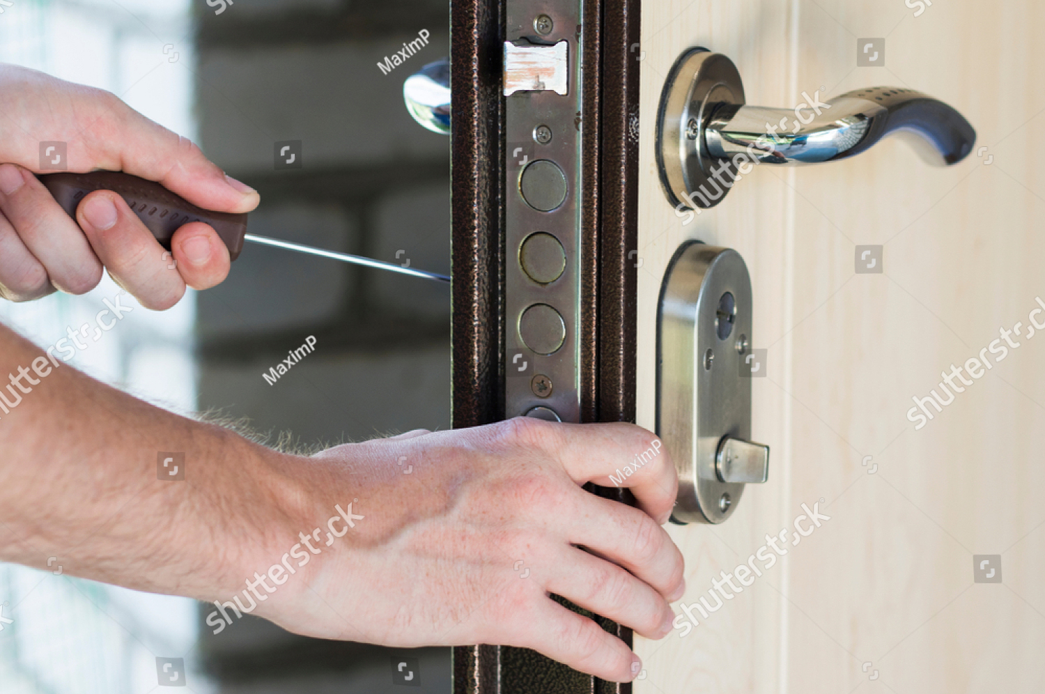 stock-photo-handyman-installing-and-repair-lock-in-the-interior-old-metal-door-1570191031.jpg