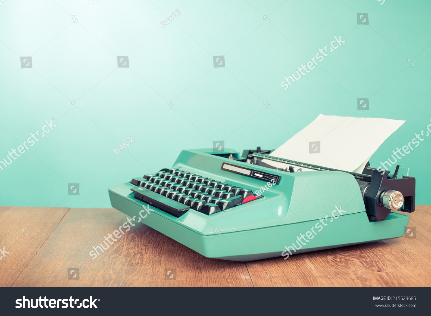 stock-photo-retro-old-typewriter-with-paper-on-wooden-table-front-mint-green-background-215523...jpg