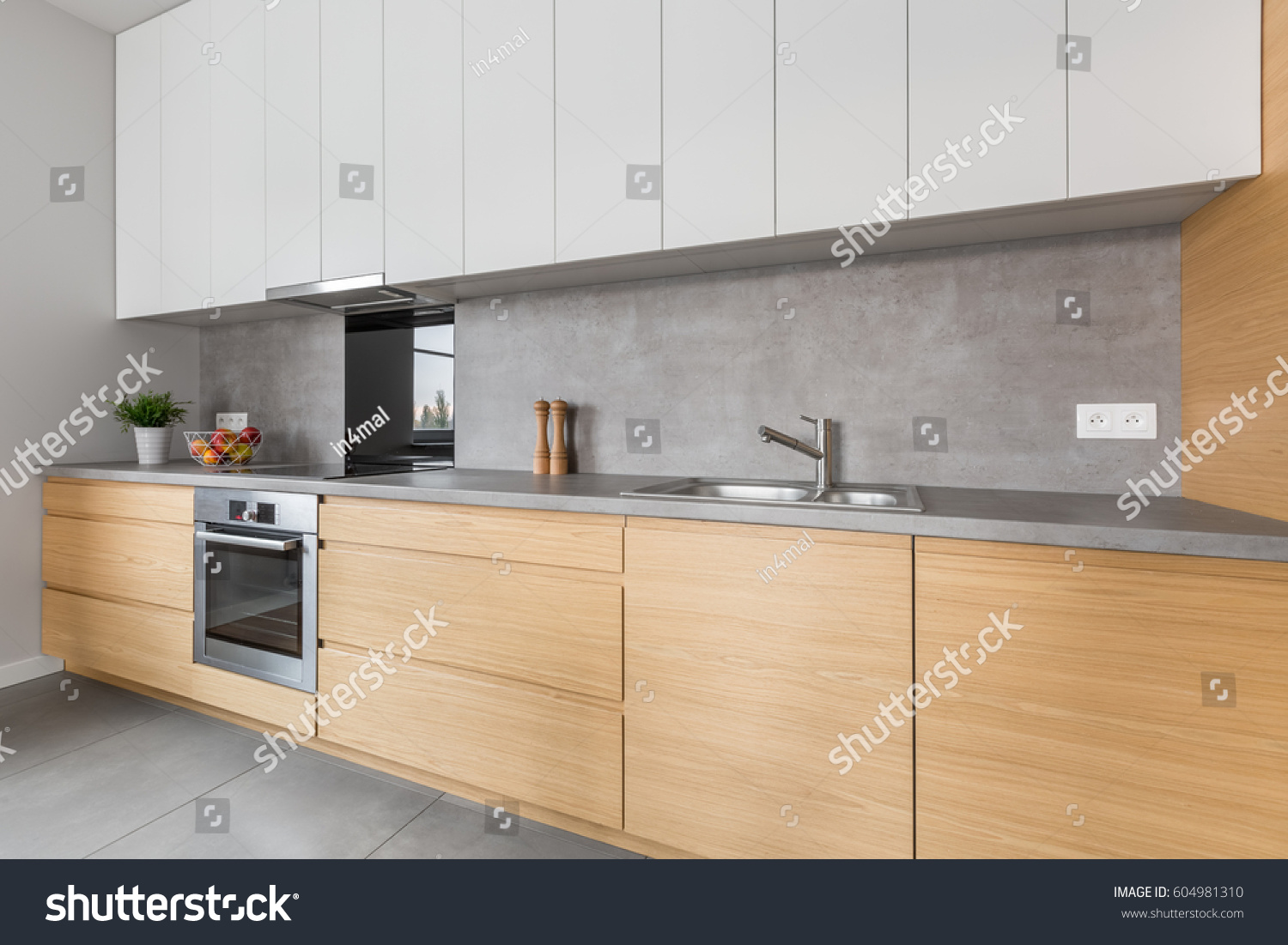 stock-photo-two-colored-kitchen-furniture-with-concrete-worktop-and-steel-appliances-604981310.jpg