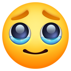 איך פרצוף עם דמעות emoji נראה על Facebook.