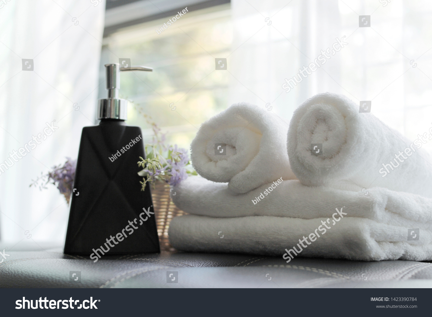 stock-photo-liquid-soap-bottle-white-towel-on-basket-in-bathroom-1423390784.jpg